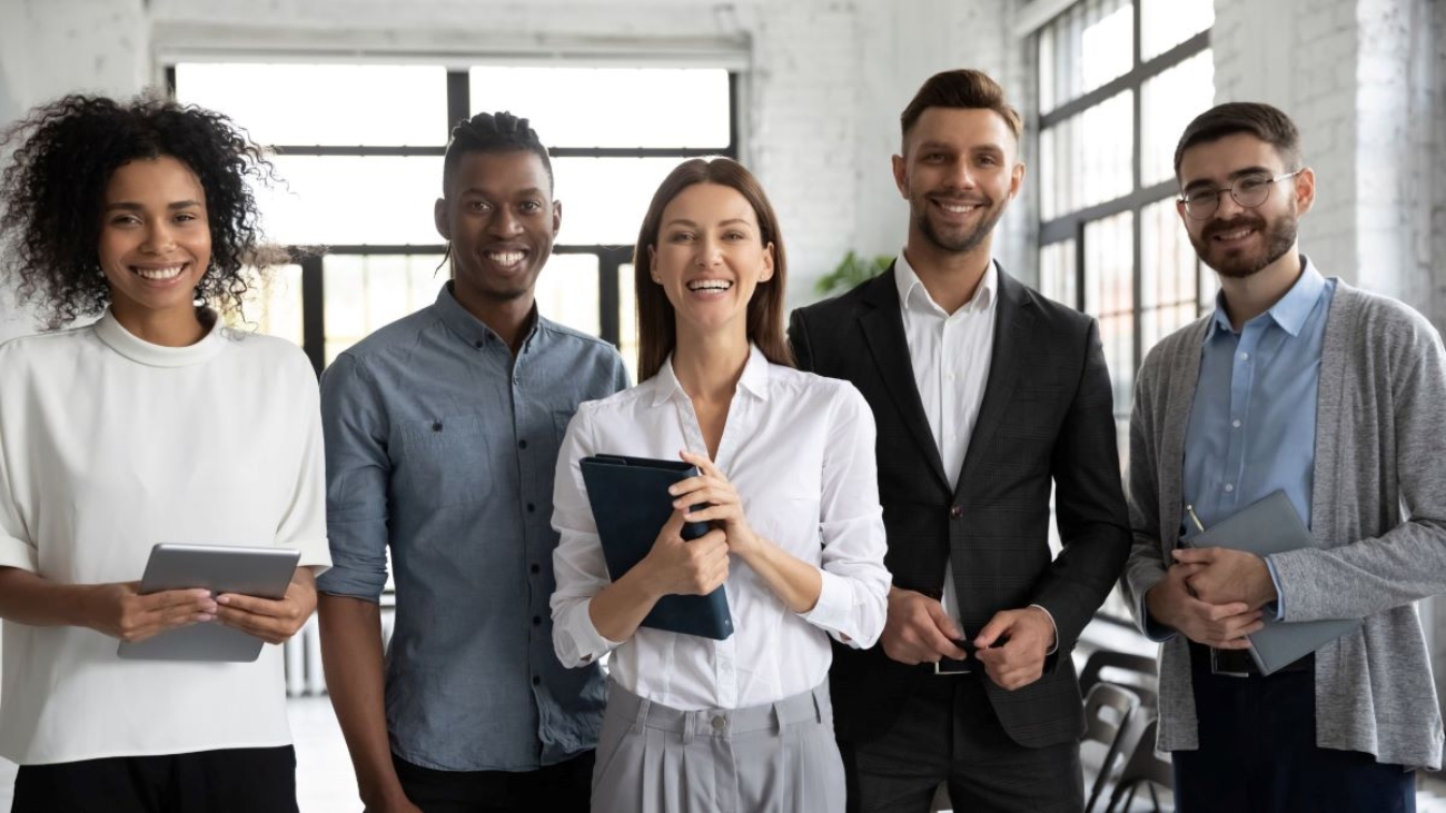 A group of diverse happy employees standing for a photo