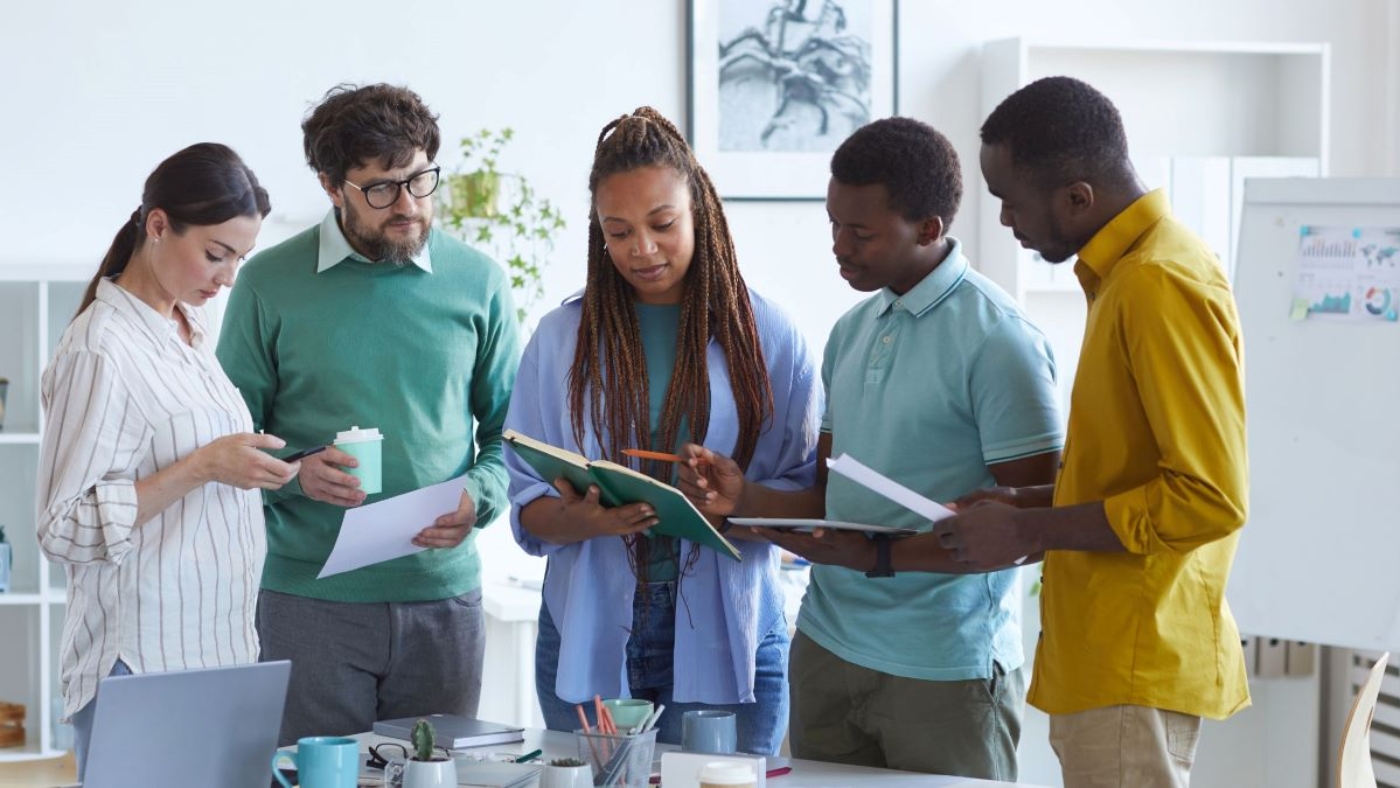 A pic showing employees discussing their work.