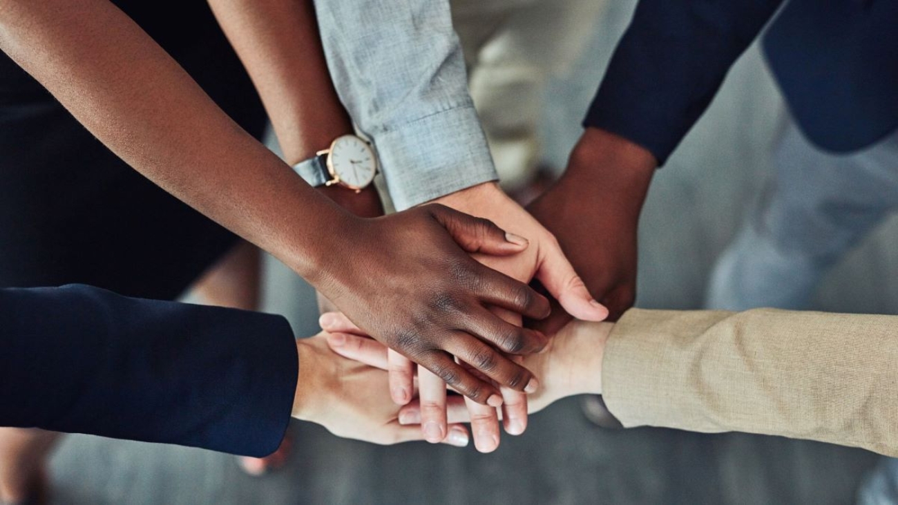 A picture of employees joining hands